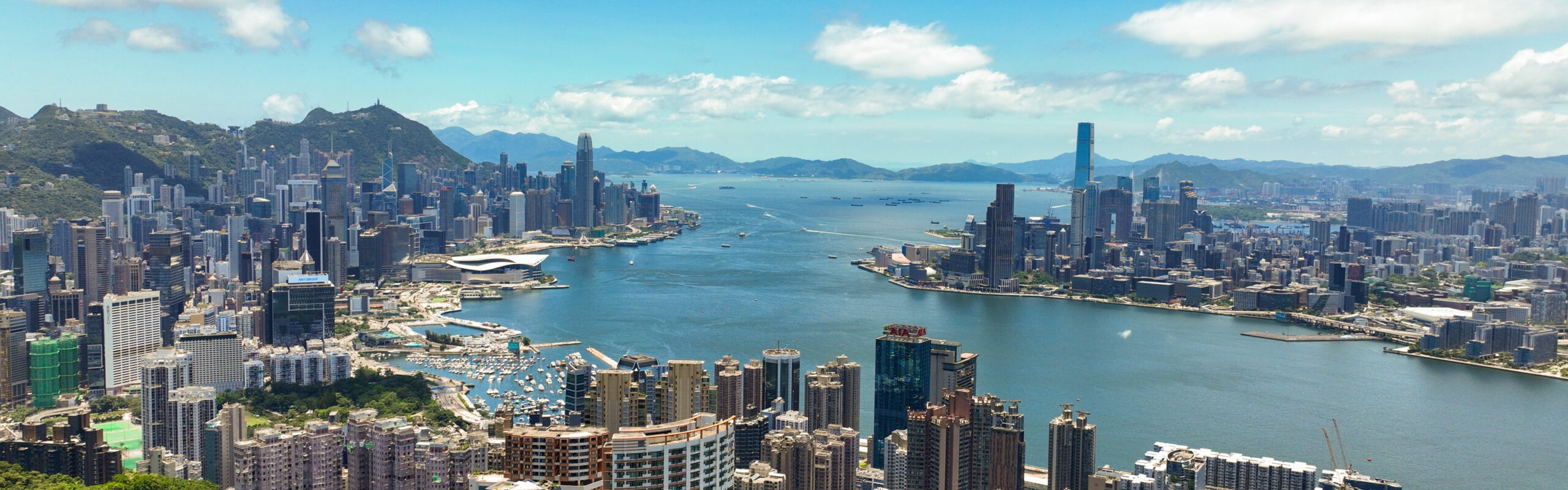 Daytime view of the Hong Kong Island skyline across Victoria Harbour